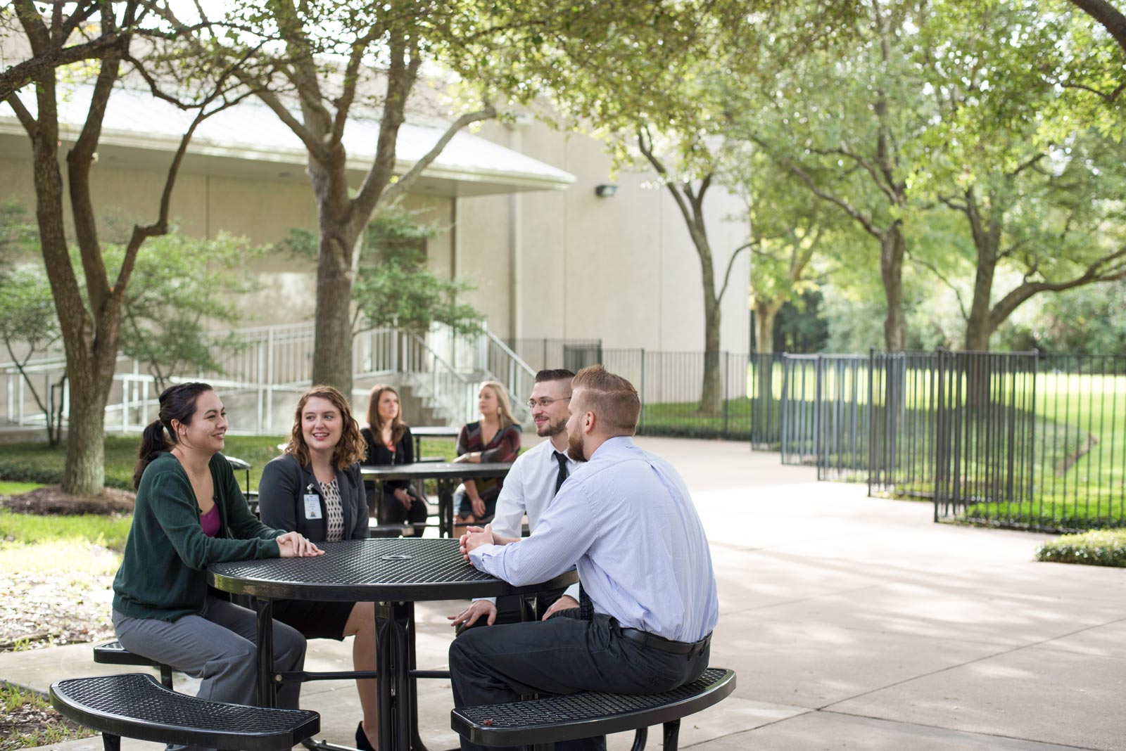 Four people talking around a table