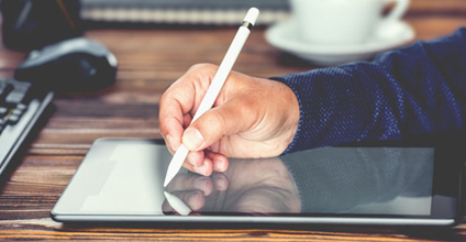 Person holding a stylus pen signing a contract on a tablet.