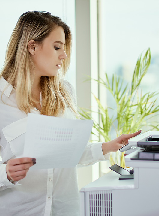 Person using a printer for MICR Check Printing