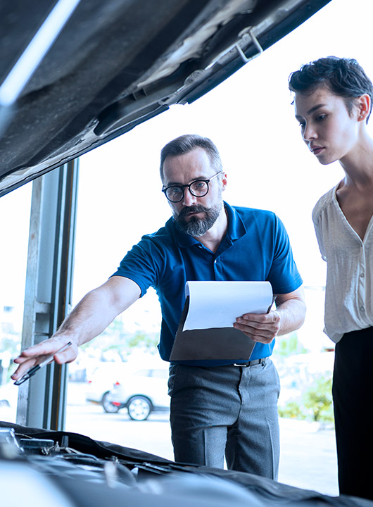 Two people evaluating a vehicle with Recall Management
