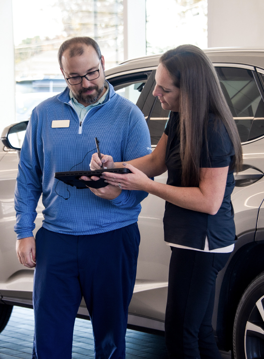 customer signing on tablet in service drive