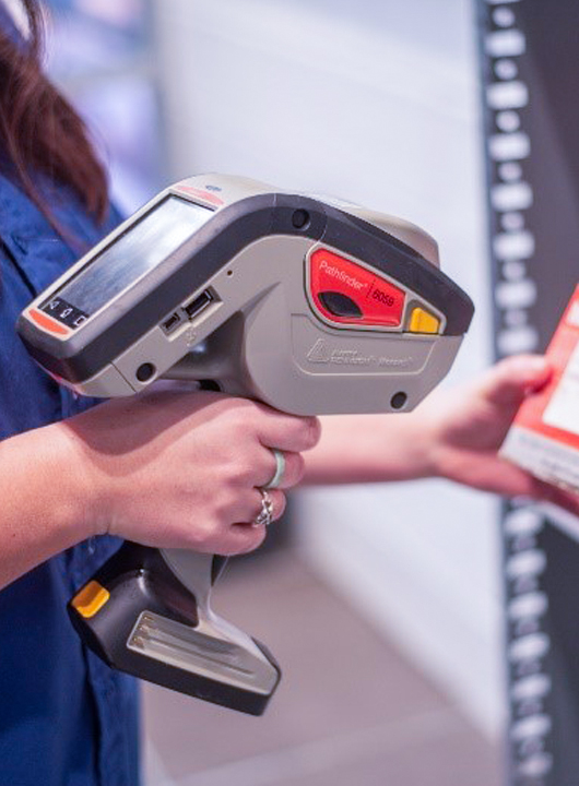 Dealership employee using barcode scanner to scan a part.