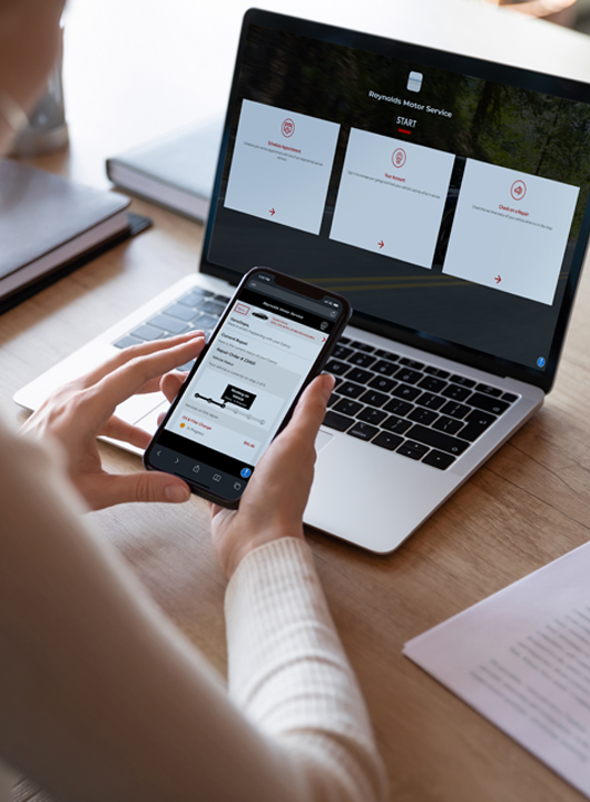 Person on phone and laptop showing a streamlined process with Service Portal 2.0