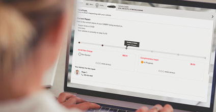 Person on computer looking at the status of their vehicle with Service Portal 2.0.