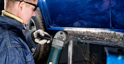 Technician completing reconditioning work on a vehicle.