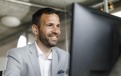 Image of a man looking at a computer screen
