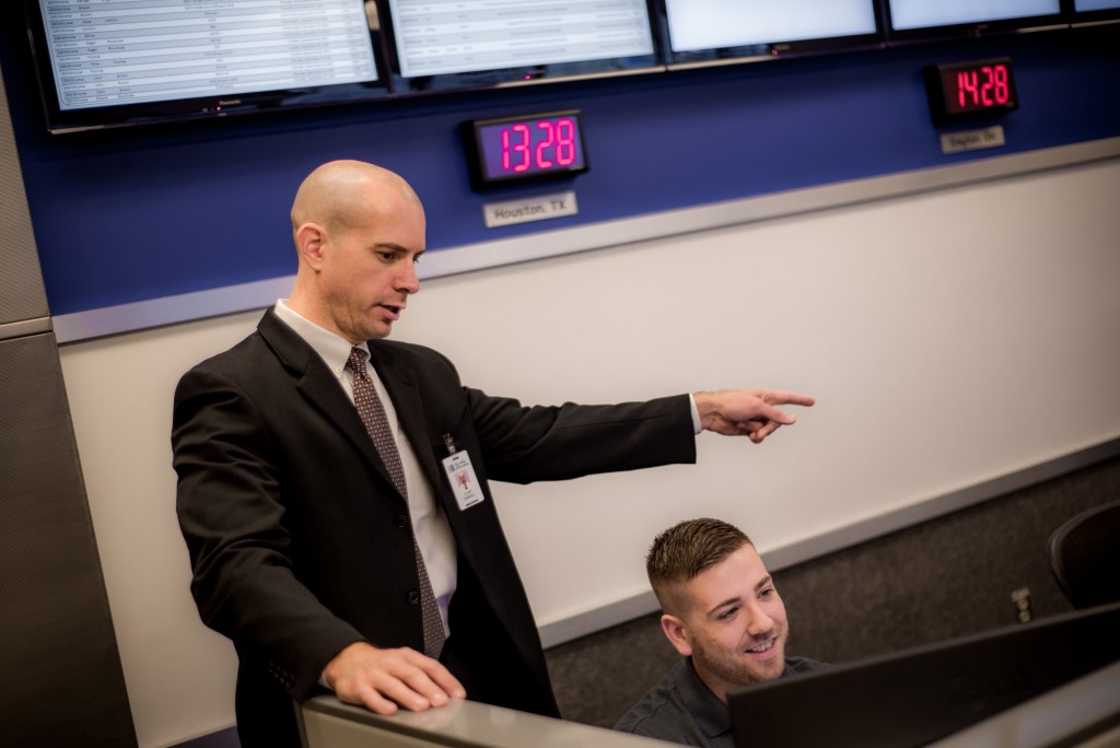 Pictured: Clint Cargill, director of IT Operations at Reynolds, assists team member Matthew M., also a veteran and Reynolds associate.