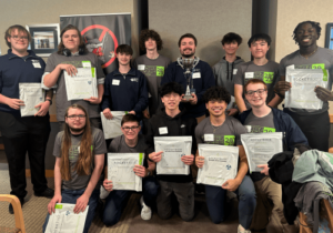 The winners holding up their certificates.