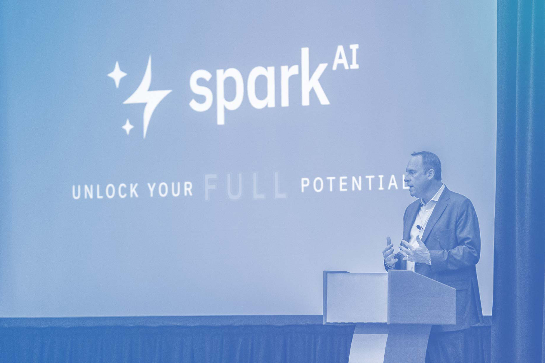 Photo with blue overlay of Chris Walsh presenting Spark AI