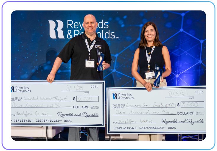 2025 Amplifiers Contest winners standing on stage holding large checks