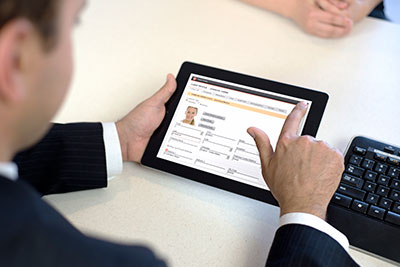 A dealership employee using a tablet