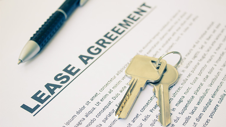 Keys on top of a lease agreement.